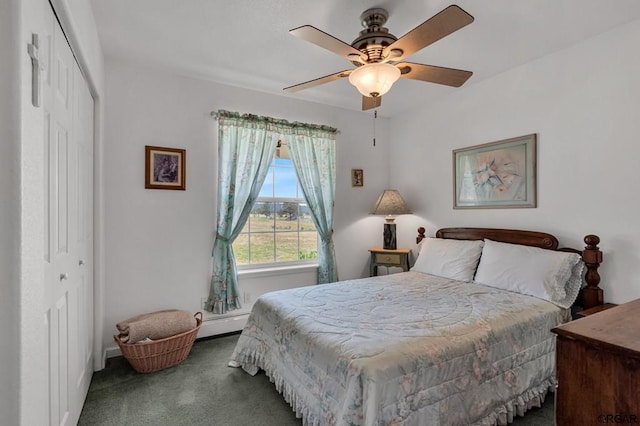 carpeted bedroom with a closet, ceiling fan, and baseboard heating