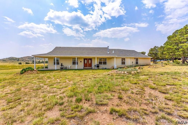 rear view of house with a lawn