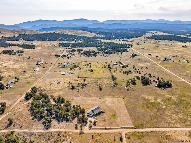 birds eye view of property featuring a mountain view and a rural view