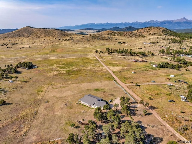 birds eye view of property with a mountain view and a rural view