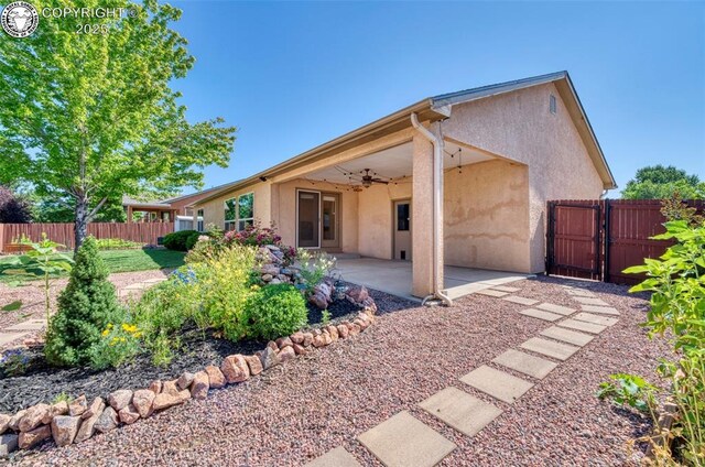 355 Antero Dr, Canon City, CO 81212 - back of property with a ceiling fan, stucco siding, a patio area, and a gate