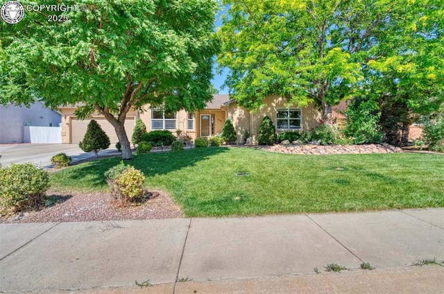 355 Antero Dr, Canon City, CO 81212 - obstructed view of property with stucco siding, a front lawn, concrete driveway, and a garage