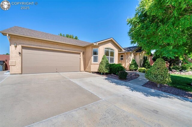 355 Antero Dr, Canon City, CO 81212 - single story home with concrete driveway, stucco siding, and an attached garage
