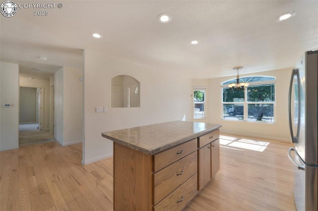 355 Antero Dr, Canon City, CO 81212 - kitchen featuring freestanding refrigerator, a kitchen island, a chandelier, light wood-type flooring, and recessed lighting