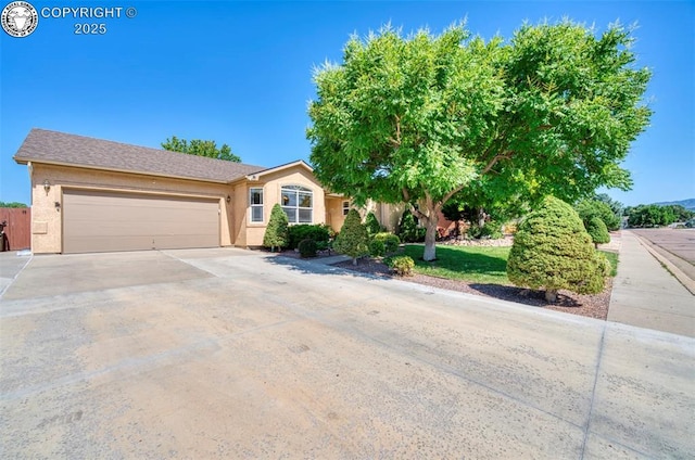 355 Antero Dr, Canon City, CO 81212 - view of front of house featuring an attached garage, driveway, and stucco siding