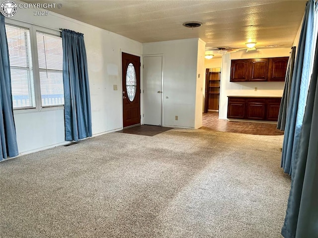 interior space with light carpet and a healthy amount of sunlight