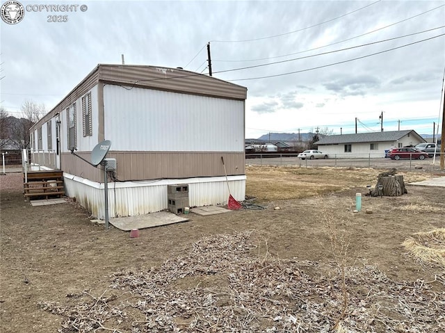 view of home's exterior featuring fence