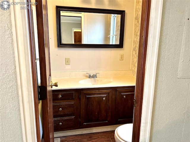 half bathroom with toilet and vanity