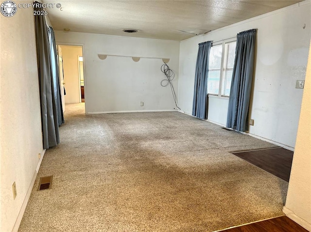 empty room with carpet floors and visible vents