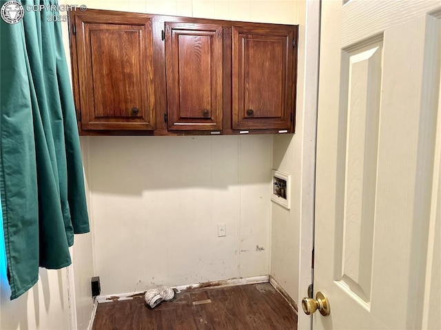 laundry area featuring hookup for a washing machine, dark wood-type flooring, and cabinet space