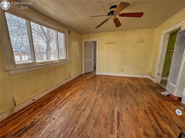 spare room with hardwood / wood-style floors and ceiling fan