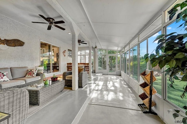 sunroom featuring ceiling fan and a wealth of natural light