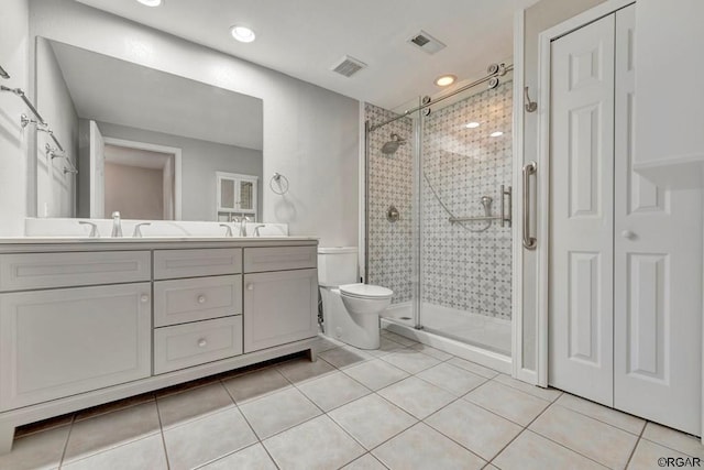 bathroom featuring an enclosed shower, vanity, tile patterned floors, and toilet