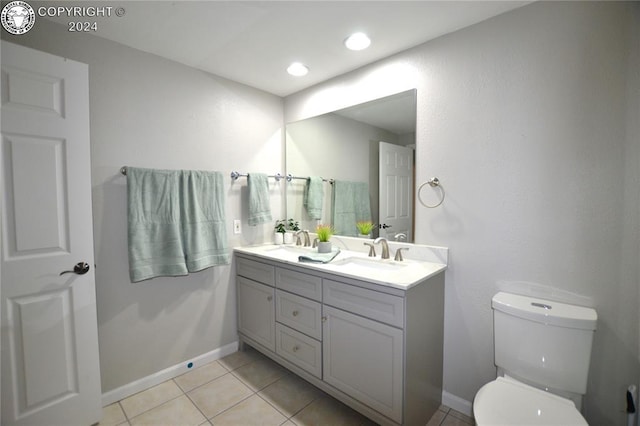 bathroom with tile patterned flooring, vanity, and toilet