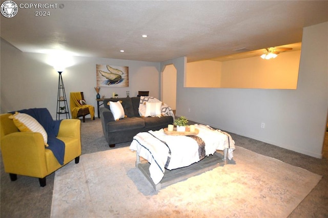 carpeted living room featuring ceiling fan