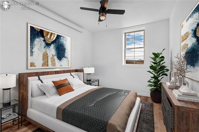 bedroom featuring hardwood / wood-style flooring and ceiling fan