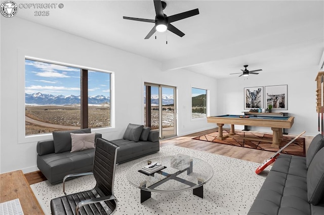 living room with ceiling fan, billiards, a mountain view, and light hardwood / wood-style flooring