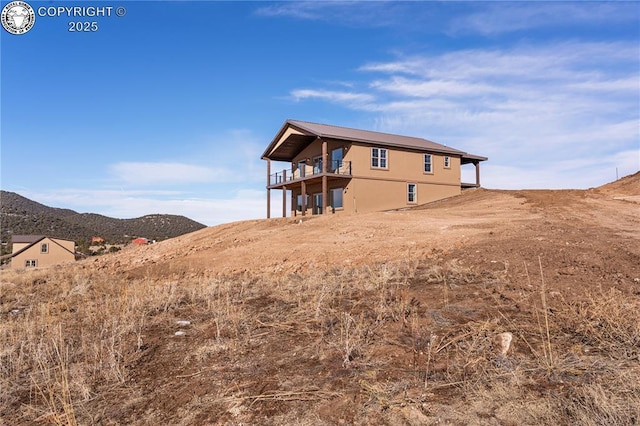 rear view of property with a mountain view