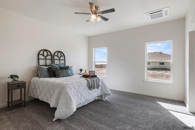 bedroom with ceiling fan and dark colored carpet