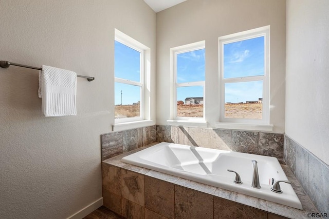 bathroom featuring a relaxing tiled tub