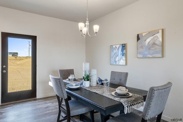 dining space featuring wood-type flooring and a chandelier