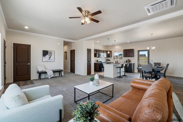 living room featuring crown molding and ceiling fan with notable chandelier