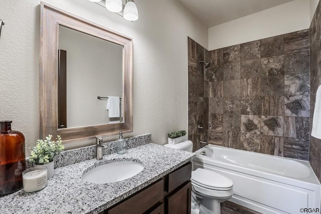 full bathroom with vanity, toilet, and tiled shower / bath combo