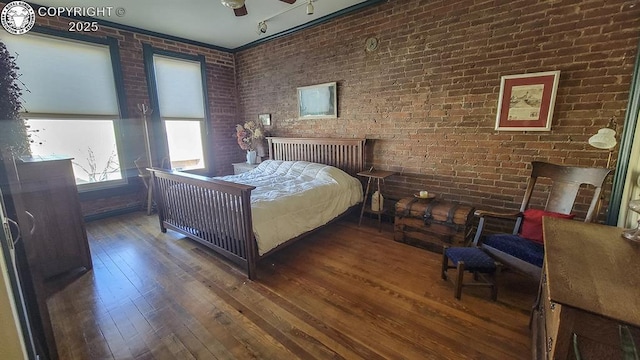 120 E Main St, Florence, CO 81226 - bedroom with brick wall, hardwood / wood-style flooring, and multiple windows