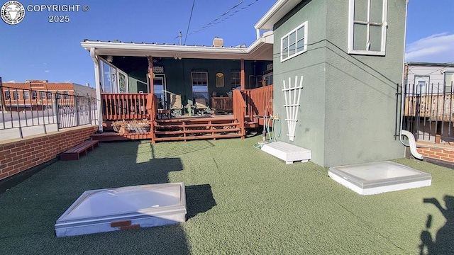 120 E Main St, Florence, CO 81226 - back of house with fence, stucco siding, and a wooden deck