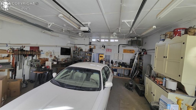 120 E Main St, Florence, CO 81226 - garage featuring a garage door opener and a workshop area