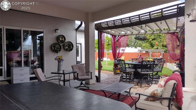 view of patio featuring outdoor dining space, fence, and a pergola