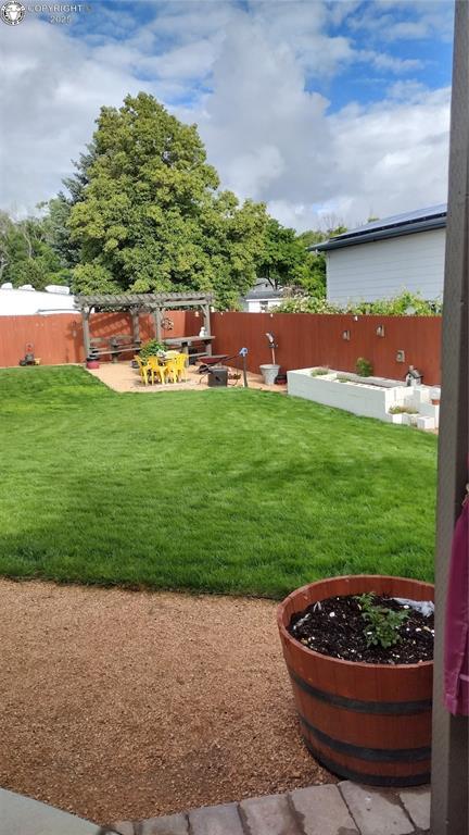 view of yard with a patio area and a fenced backyard