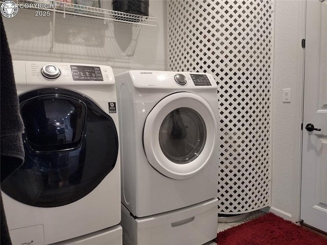 laundry room with laundry area and washing machine and clothes dryer