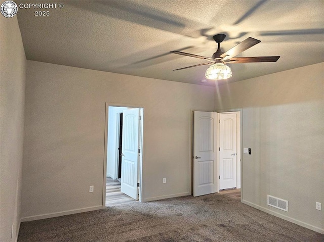 unfurnished bedroom with ceiling fan, carpet, and a textured ceiling