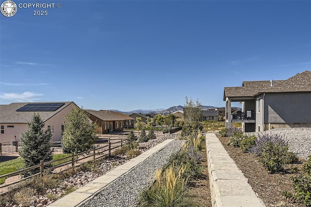 view of yard with a mountain view and a balcony