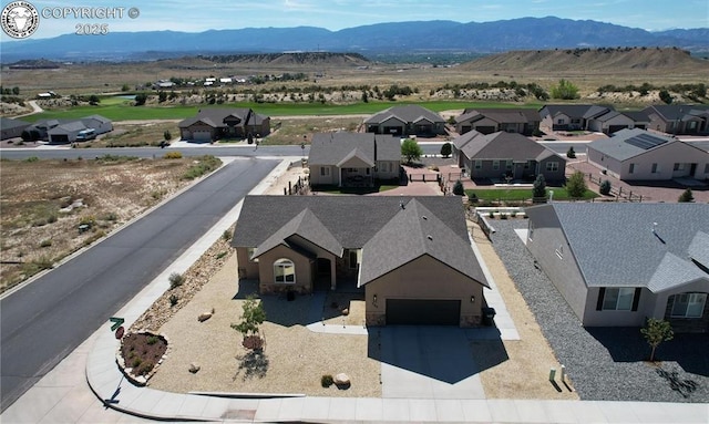 birds eye view of property with a mountain view