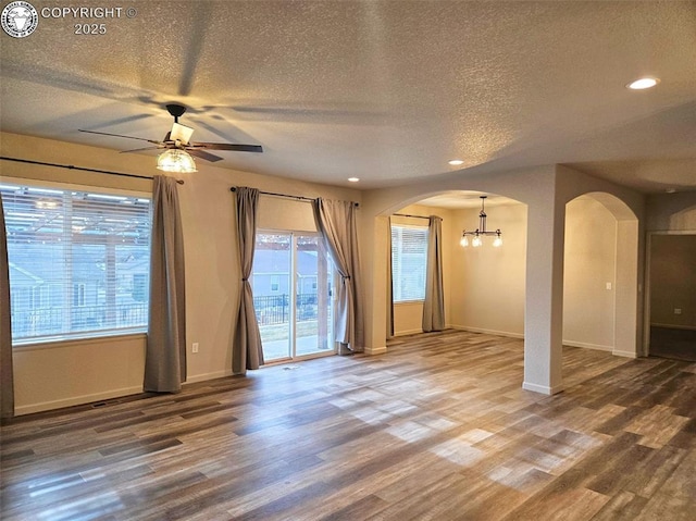 spare room featuring hardwood / wood-style flooring, ceiling fan, and a textured ceiling