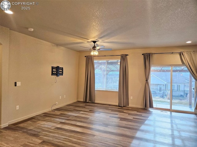 unfurnished room with hardwood / wood-style floors, a textured ceiling, and ceiling fan