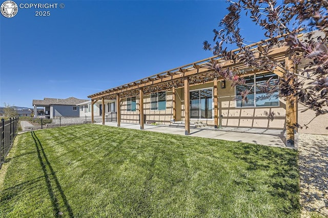 rear view of house featuring a yard and a patio