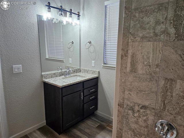 bathroom with vanity and hardwood / wood-style flooring