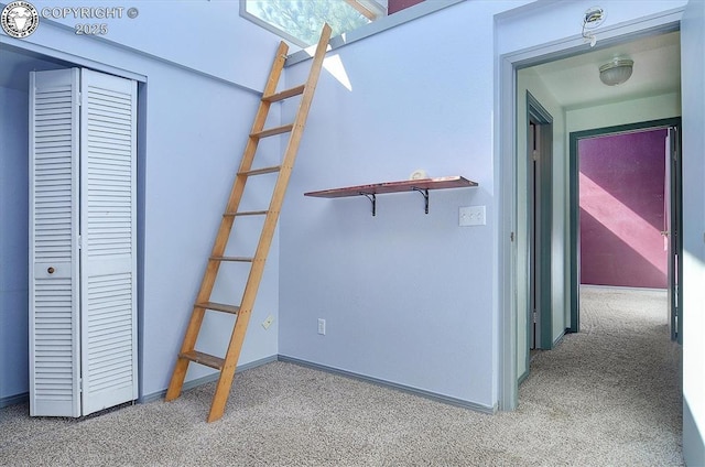 interior space with baseboards and carpet floors