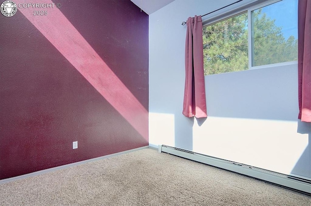 unfurnished room featuring a baseboard heating unit, baseboards, and carpet floors