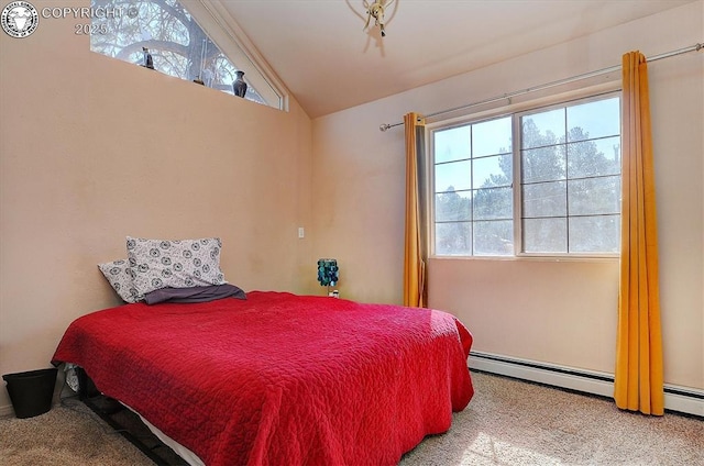 bedroom with carpet floors, baseboard heating, and vaulted ceiling