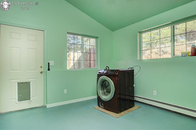 washroom with baseboards, baseboard heating, washer / dryer, and laundry area