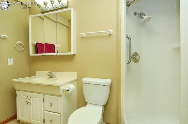 bathroom featuring vanity, toilet, and walk in shower