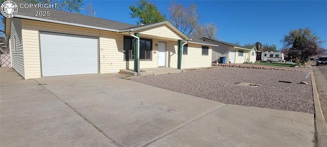 single story home with an attached garage, driveway, and covered porch