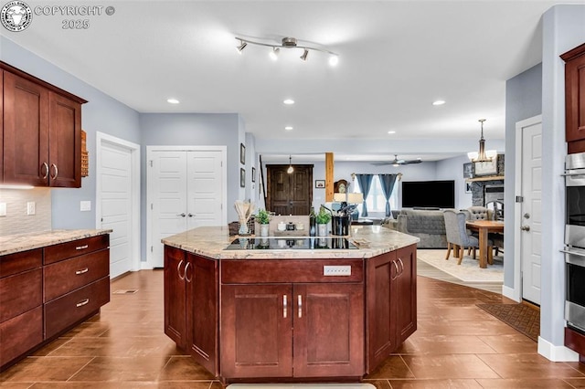432 Red Rock Cir, Penrose, CO 81240 - kitchen featuring black electric stovetop, ceiling fan, recessed lighting, a stone fireplace, and decorative backsplash