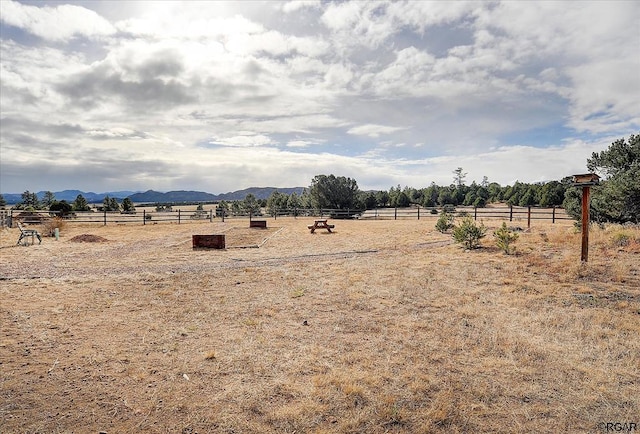 view of yard with a mountain view and a rural view