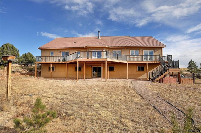 back of property featuring a wooden deck