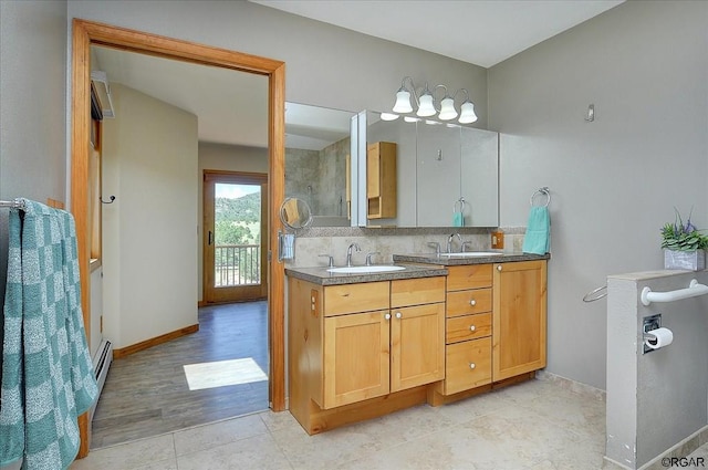 bathroom featuring vanity and backsplash